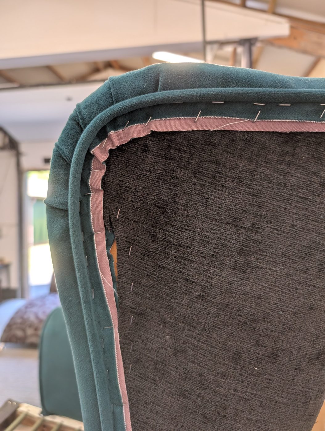 Matching piping pinned along the wing — the detail that defines the edge.