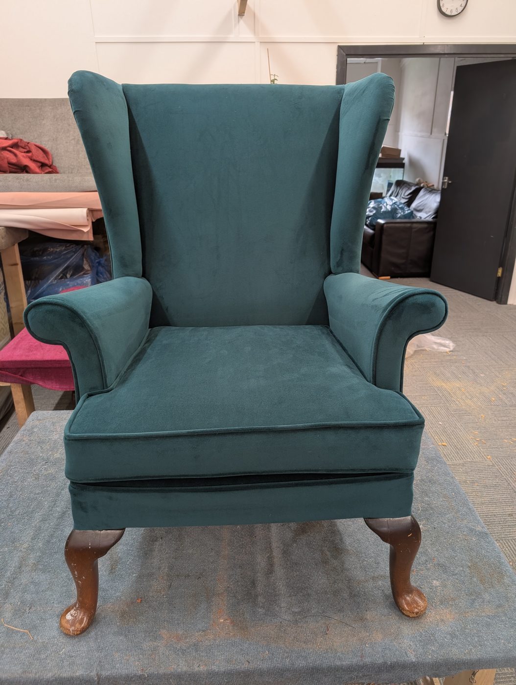 The finished chair — reborn in teal velvet, the same frame, a completely new life.